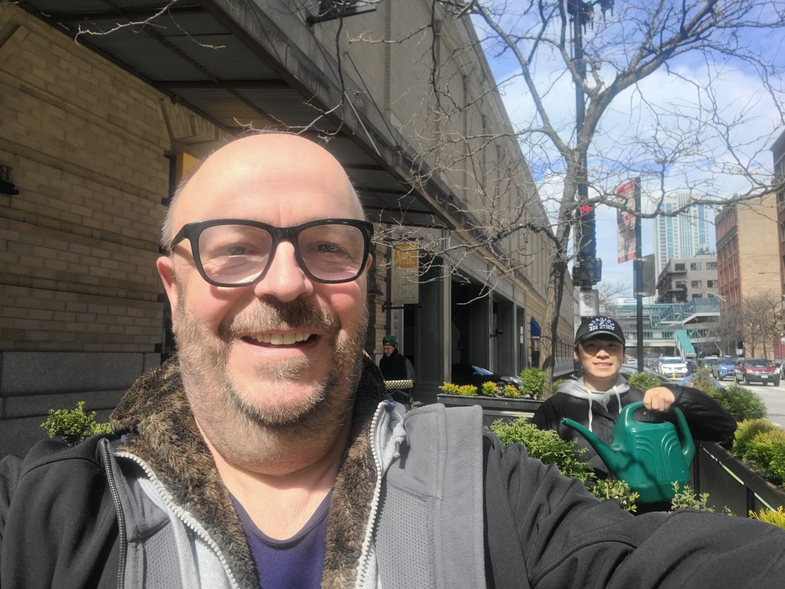 Paul and a crew member watering street planters in downtown Chicago